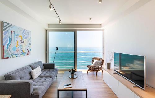 a living room with a couch and a large television at Cozy Apartment In Benalmadena With Wifi in Benalmádena