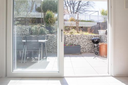 an open door to a patio with a table outside at Elegant Suites Murten in Murten