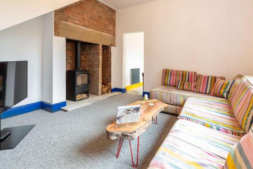 a living room with a couch and a fireplace at Host & Stay - Temple Gardens in Lincoln