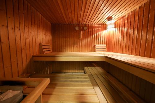 a sauna with two chairs and a bench in it at Hotel Grüsch in Grüsch