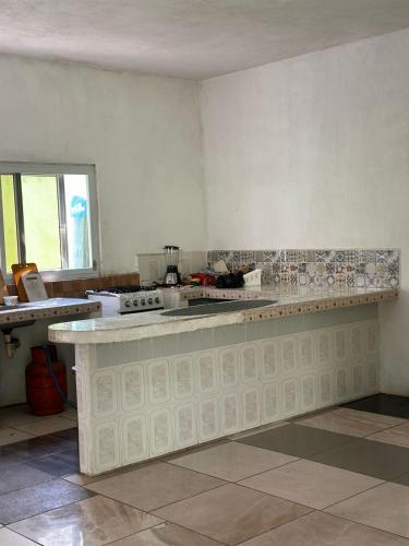 a kitchen with a counter top in a room at Chalet brisas del mar in Chiquimulilla