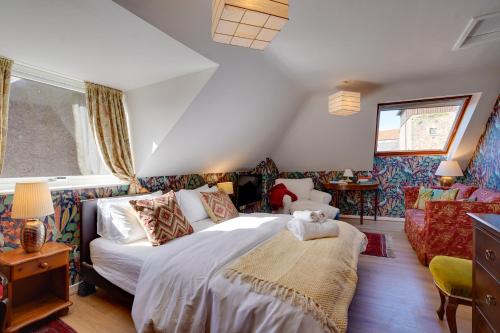 a bedroom with a large bed in a room at NEW The Old Smokehouse Central, Bohemian Room in Berwick-Upon-Tweed