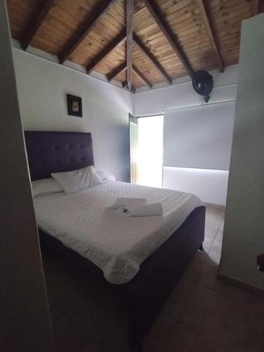 a bedroom with a bed with a laptop on it at Sea Natural in San Gil
