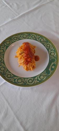 a plate of spaghetti with sauce on a table at Country Hotel & Resort I Calanchi in Ripatransone