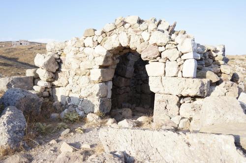 an old stone building on the side of a hill at Akrotirio Tainaro House in Marmari
