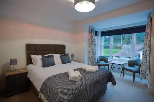 a bedroom with a large bed with a large window at Luxury Large Five Bedroom Family House Sleeps 10 in Milton Abbas