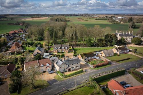 an aerial view of a village with houses and a road at Finest Retreats - The Stables at Crimplesham in Stradsett
