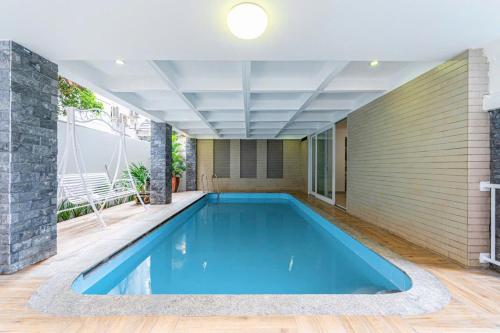 a swimming pool in the middle of a house at Villa La Rose Blanc Thảo Điền in Ho Chi Minh City