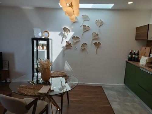 a dining room with a glass table and some shells on the wall at Casa do Romezal in Peso da Régua