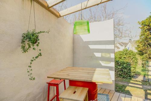 a wooden table and stool on a patio at Appartement et terrasse Dinard 4p in Dinard