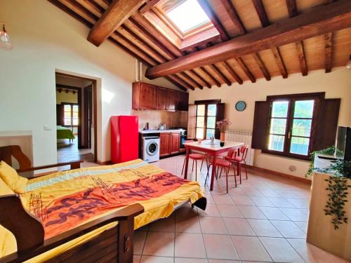 a bedroom with a large bed and a kitchen at Casa con piscina tra le colline in Pieve di Santa Luce