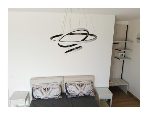 a chandelier hanging over a bed in a room at La Principessa Nera B&B in Ostra