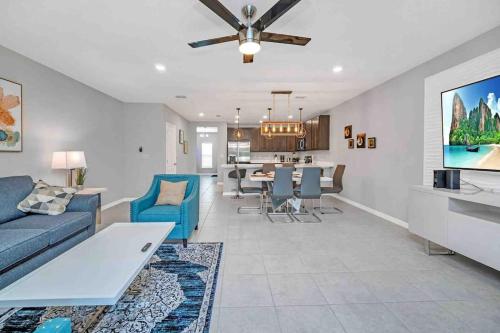 a living room with a couch and a dining room at SUPER BOHO CHIC Stylish Blend NEAR Disney in Kissimmee