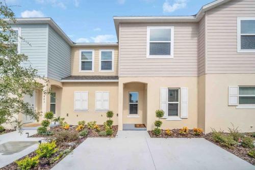 a large house with a driveway at SUPER BOHO CHIC Stylish Blend NEAR Disney in Kissimmee