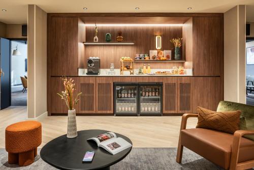 a living room with a couch and a table at Novotel Paris La Défense Nanterre in Nanterre