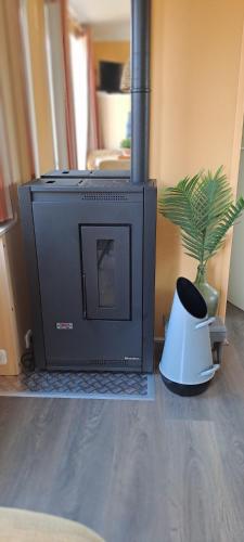 a television sitting on the floor next to a potted plant at Vakantie bij 17 in Serooskerke