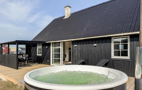 a hot tub on the deck of a house at 2 Bedroom Stunning Home In Harboøre in Harboør