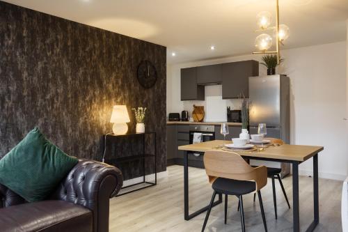 a kitchen and living room with a table and chairs at Homey 1 Bedroom Duplex in Conditioning House in Bradford