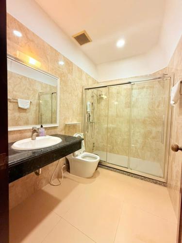 a bathroom with a shower and a sink and a toilet at Villa La Rose Blanc Thảo Điền in Ho Chi Minh City