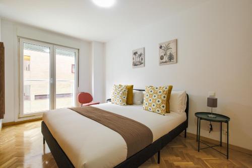 a bedroom with a large bed and a window at Dobo Getafe Uruguay in Getafe