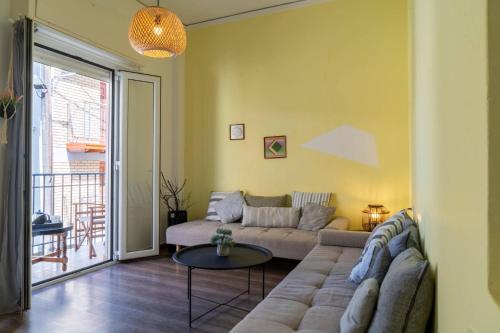 a living room with a couch and a table at Chersonissos Central Apartment in Hersonissos