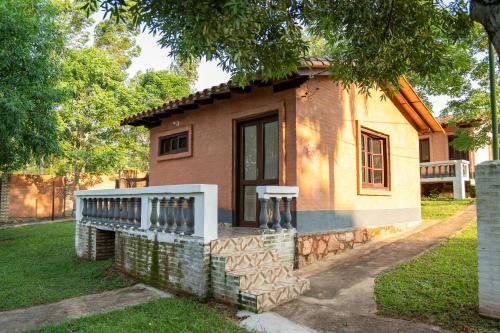 a small house with a fence on the side of it at Los Cantares in Piribebuy