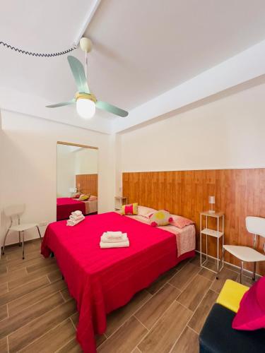 a bedroom with a red bed and a mirror at Balestrate Mare Centro Wi-Fi Self Check-in Aria Condizionata in Balestrate