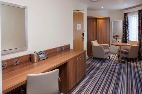 a waiting room with avertisement for avertisementosateosateosateosateosateosateosate at Holiday Inn Norwich North by IHG in Norwich