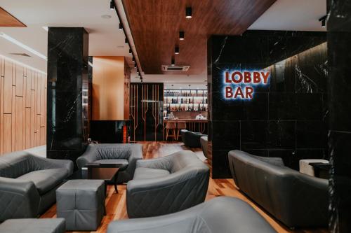 a bar with grey chairs and a sign that reads lobby bar at Santé SPA Hotel in Velingrad