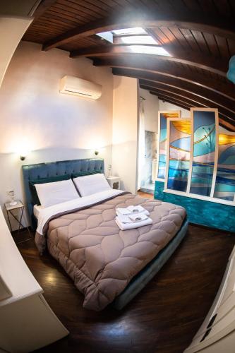 a bedroom with a large bed with a blue headboard at La Residenza Isabella in Milan