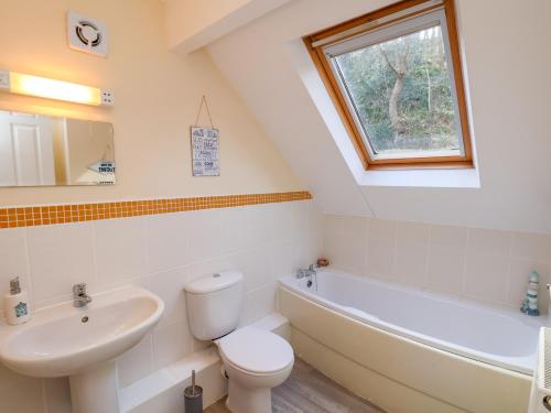 a bathroom with a sink and a toilet and a bath tub at No 18 Riverside Walk Kingfisher in Whitby