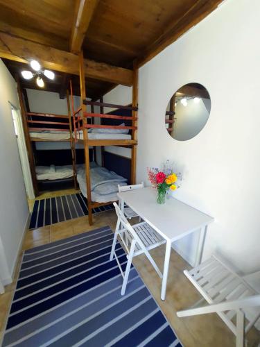 a room with a table and a bunk bed at Dorci Vendégház - A piece of peace in Cserépfalu