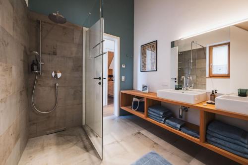 a bathroom with two sinks and a shower at Schmiedgut Bad Aussee in Bad Aussee