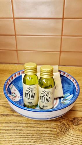 two jars of olives on a plate on a table at B&B La Casa Di Bianca in Manfredonia