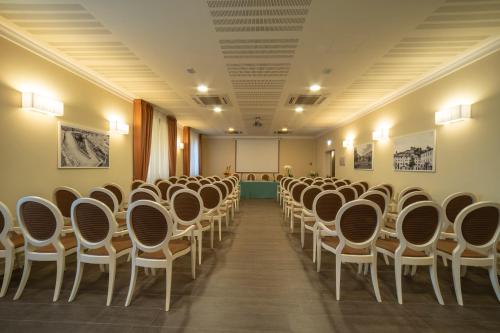 a room with rows of chairs and a podium at Hotel Palazzo San Lorenzo & Spa in Colle Val D'Elsa