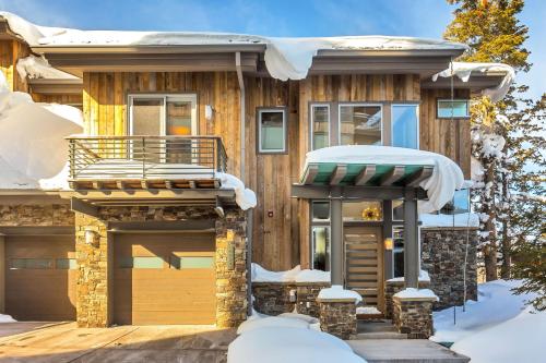 a house covered in snow with a porch at Stein Eriksen Residences in Park City