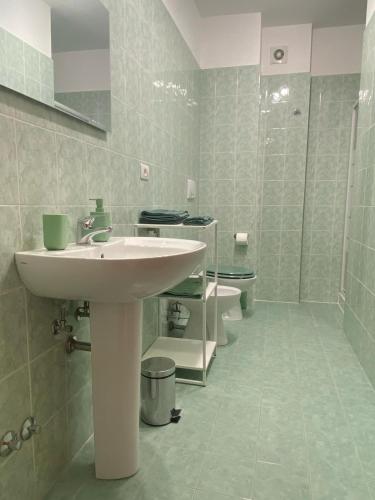 a bathroom with a sink and two toilets at Fontana Apartment 2 in Perugia