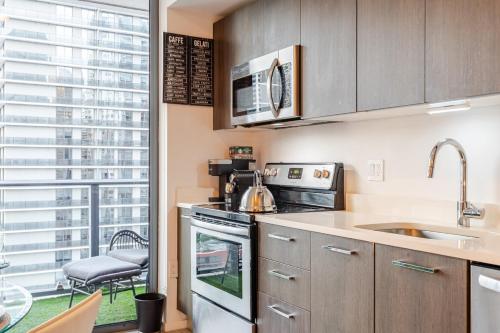 a kitchen with a sink and a stove at Brickell Bay View in Miami