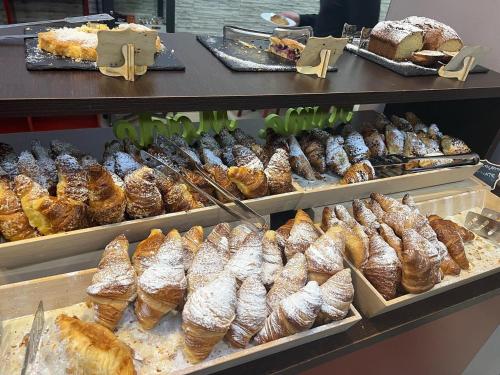 a bakery with different types of bread and pastries at Miramonti Simple Stay in Turin