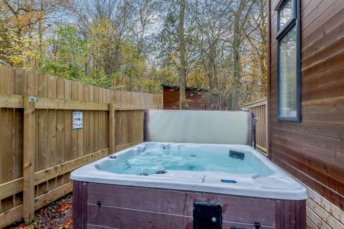 a hot tub in a backyard with a fence at Best Western Plus Kenwick Park Hotel in Louth