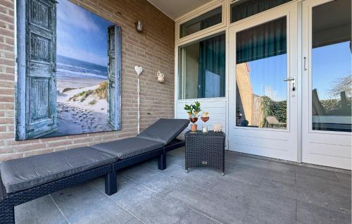 a bench sitting on the side of a house at 2 Bedroom Cozy Home In Bruinisse in Bruinisse