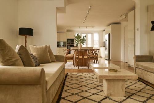a living room with a couch and a table at Europa House Apartments in London