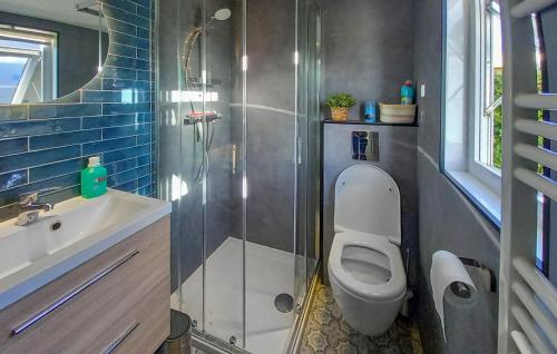 a bathroom with a shower and a toilet and a sink at Beautiful StaCaravan In Goedereede in Goedereede