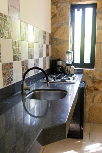 a kitchen with a sink and a stove at Yauik in Tequesquitengo