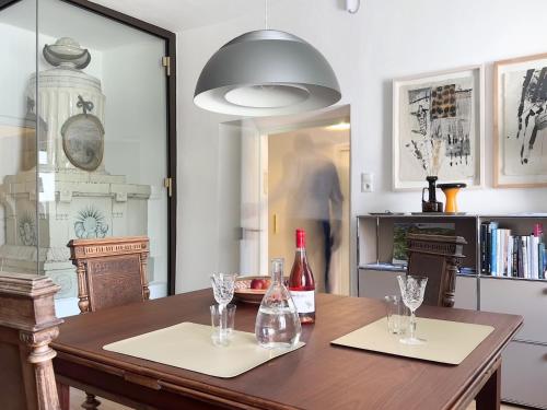 a dining room table with glasses and a lamp at apartment beletage in San Lorenzo di Sebato