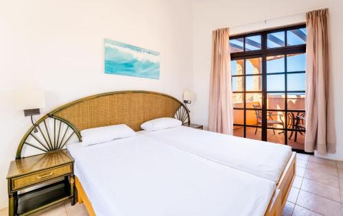 a bedroom with a bed and a large window at Bakour Fuerteventura La Pared in La Pared