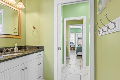 a bathroom with a sink and a mirror at Cherry Bomb Private heated Pool, Elevator in Ocean Isle Beach