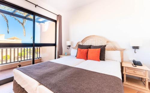 a bedroom with a bed and a large window at Bakour Fuerteventura La Pared in La Pared