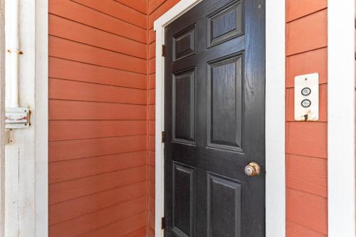 a black door on the side of a house at Cherry Bomb Private heated Pool, Elevator in Ocean Isle Beach