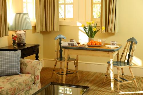 a living room with a table with a bowl of oranges at Tallman Hotel in Upper Lake